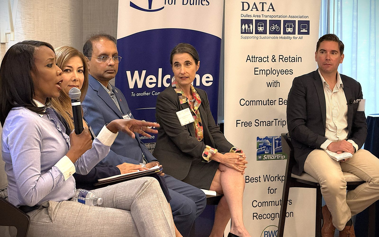 Five panelists discuss commuter programs beside DATA and Committee for Dulles banners.