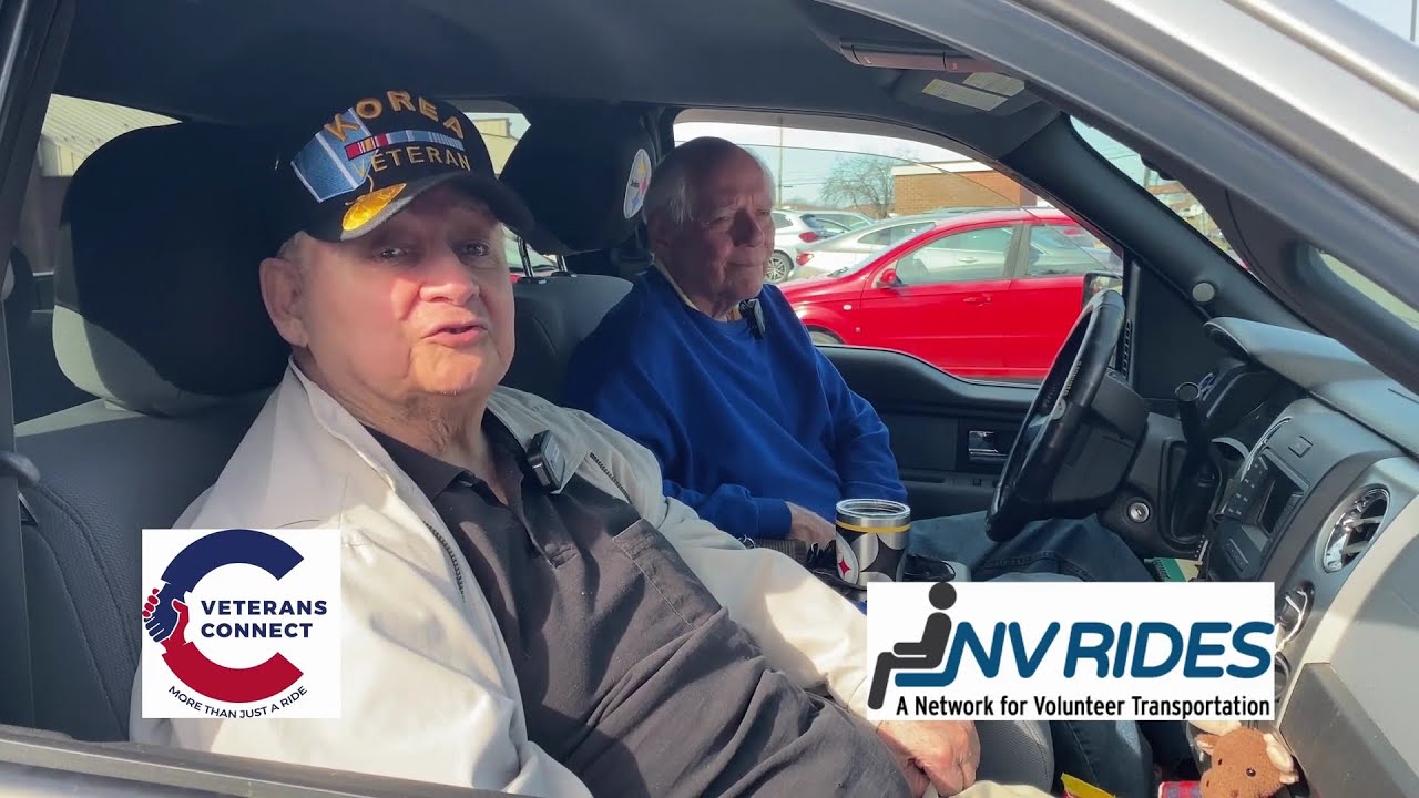 A Veterans Connect volunteer driver and the veteran he drives, seated together during a filmed interview.